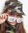 The girl in the camouflage hat and funny glasses with the inscription 2018
