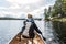 Girl canoeing with Canoe on the lake of two rivers in the algonquin national park in Ontario Canada on sunny cloudy day