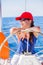 Girl captain on board of sailing yacht on summer cruise. Travel adventure, yachting with child on family vacation.