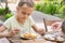 Girl carefully coated with confectionery glaze Easter cupcakes