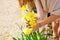 Girl cares for flowers in garden in country house