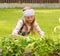 Girl cares for the plants in the garden