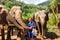 Girl caress three elephants at sanctuary in Chiang Mai Thailand