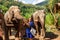 Girl caress three elephants at sanctuary in Chiang Mai Thailand