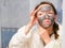 The girl is caring for the face. Cosmetic black mask. A woman brings beauty to her face, gets rid of black dots with a black mask