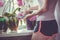 Girl caring for potted flowers on a windowsill