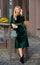 Girl carry handbag. Glamorous clutch accessory. Fashion blog. Elegant woman in green velour dress. Velvet fashion trend