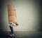 Girl carrying several boxes on her back in equilibrium