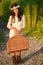 Girl carrying vintage picnic basket