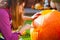 Girl carving jack-o-lantern