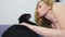 Girl with a cat. Beautiful blonde girl lying in bed and caressing her black cat. Caring for animals. love for pets