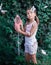 Girl catches butterflies with a net in the summer in the garden