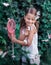 Girl catches butterflies with a net in the summer in the garden