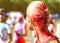 Girl celebrates holi festival, back view.