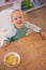 Girl, cereal and play for fun in home, child and morning nutrition with table. Smart, math education with happy vitamins