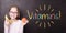 Girl at the chalkboard with fruits and `Vitamins!` sign