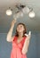 Girl changes light bulb