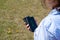 Girl charging smartphone without cable from induction power bank in the park. Modern technology. Selective focus