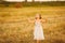 Girl chasing soap bubbles on field sunset