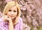 Girl with Cherry Blossom. Beautiful Blonde Young Woman