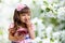 Girl with cherry bowl in apple garden