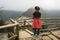 Girl child admires the beautiful scenery of North Vietnam. Young girl tourist posing in traditional Vietnamese dresses against