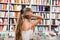 Girl child bemused a lot of books in a bookstore