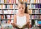 Girl child considers the book in a bookstore