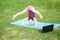 Girl child doing sport workout outdoor online. Video yoga stretching on Internet in park. Kid learning fitness gymnastics on