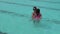 Girl child jumps into swimming pool