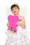 Girl child lost tooth fairy dressed in white gown with wings show big tooth shape made from paper