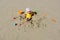 Girl child playing on the beach buries herself in the sand.