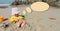 Girl child playing on the beach buries herself in the sand, she thinks or says and a place for,