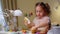 Girl child is playing with toys in a cozy room at home.