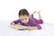 Girl child reading book lying on bed