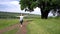 Girl child runs along the village path