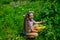 Girl child small farmer proud with harvest, yellow squash