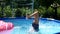 Girl child in swimming mask dive in outdoor pool on sunny summer day, diving