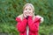 Girl child touch happy face with palms on autumn day