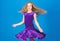 Girl child wear velvet violet dress. Kid fashionable dress looks adorable. Ballroom dancewear fashion concept. Kid