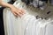 Girl chooses a white shirt in the store Selection of new clothes close-up of hands