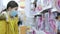 Girl choosing doll in toy shop during pandemic