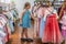 Girl choosing dress for sale in chinese shop