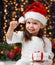 Girl in christmas decoration with gift, dark background with illumination and boke lights, winter holiday concept