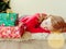 Girl with christmas gift. Little girl dreams of gifts for Christmas. The child lies on the floor near the gifts