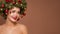 Girl with christmas wreath on her head. Brown background