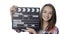 Girl with clapperboard winking