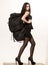 Girl classic black dress and touristic backpack equipment. Elegance and capaciousness. Woman takes with her all she owns