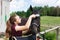 Girl is cleaning a horse