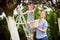 Girl climbed on the ladder  picking cherries with her mom